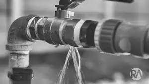 Industrial water pipe with valve and flow control for fluid regulation.