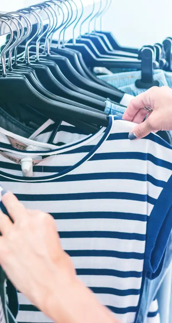Retail clothing hangers with striped shirts on a rack, emphasizing data-driven marketing.