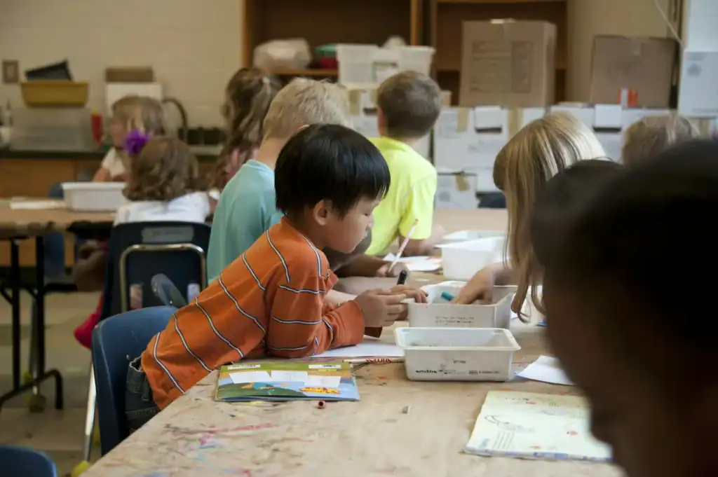 Children engaging in educational activities, promoting youth philanthropy and community support.
