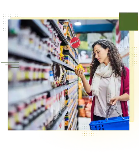 Woman shopping in retail store aisle with products on shelves.