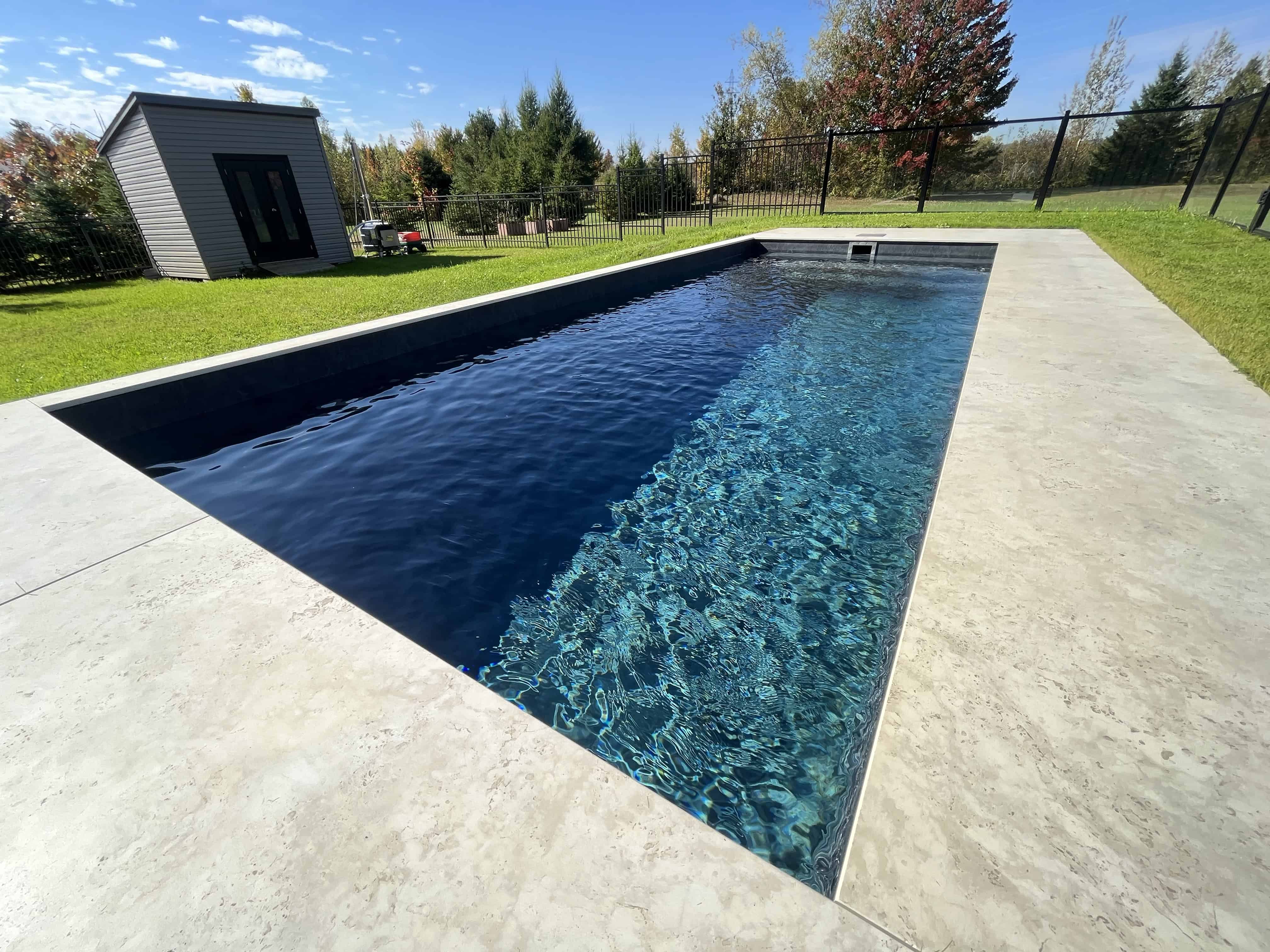 Bayto precast concrete pool in a Calgary backyard, installed by Sculpted Earth
