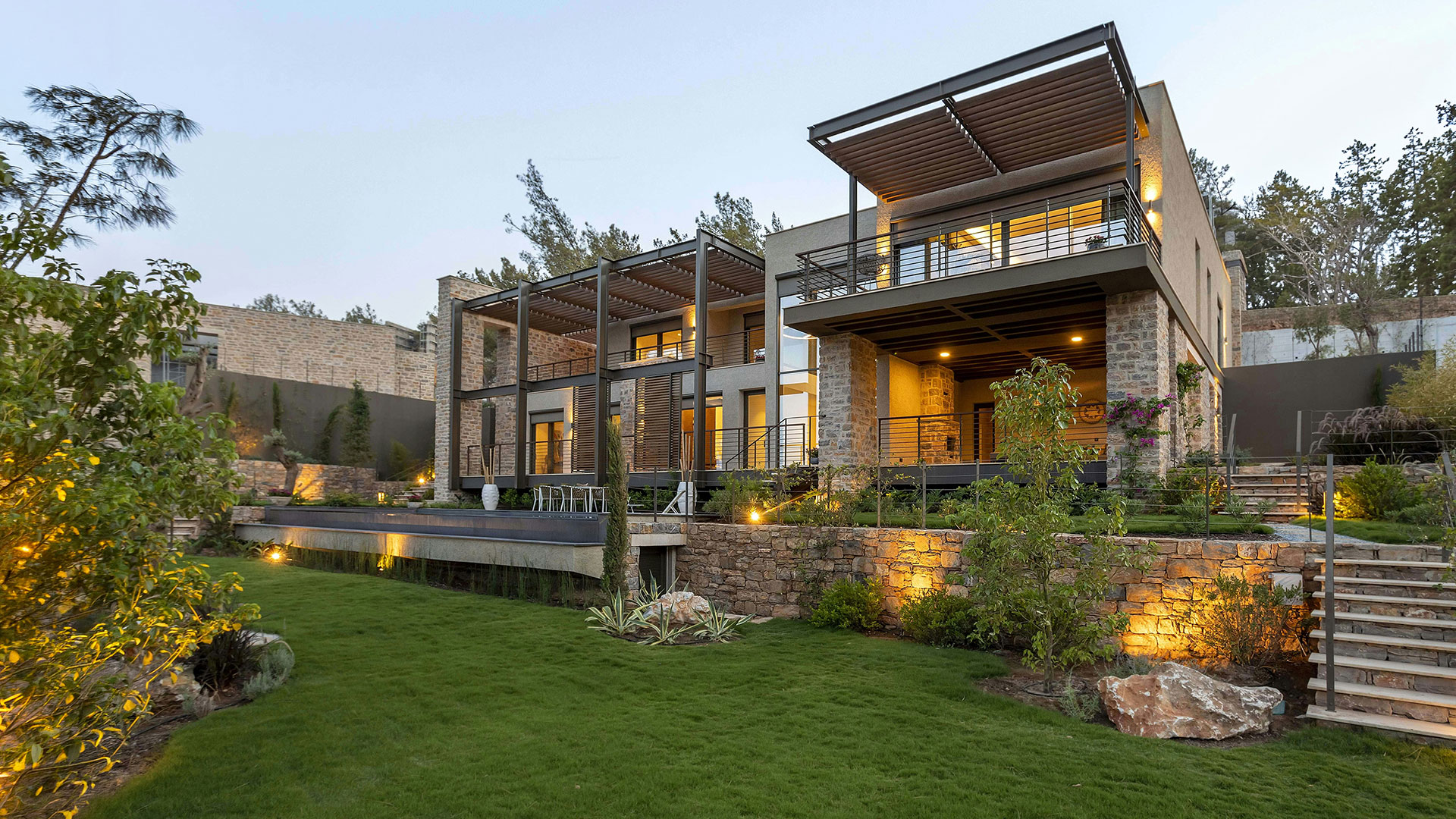 Feature home with illuminated landscape