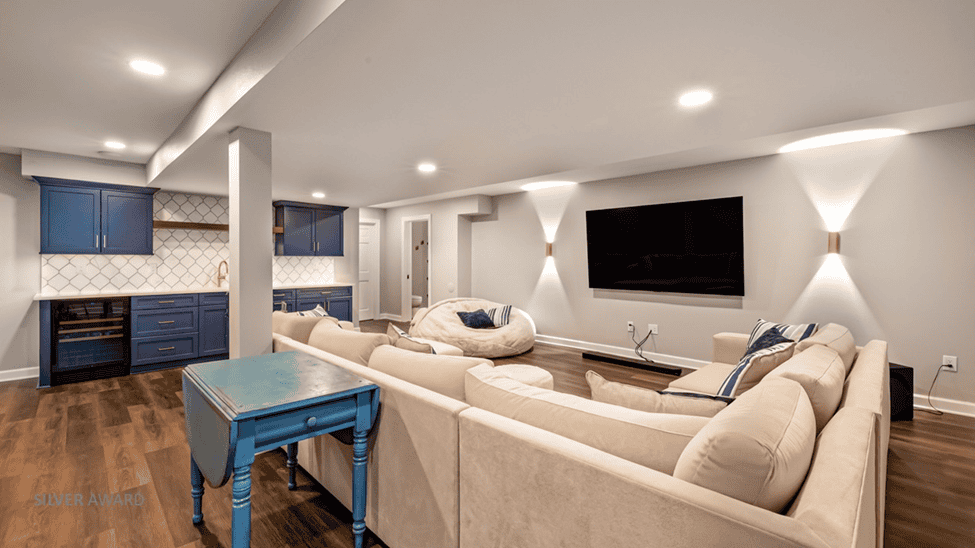Finished basement with TV, sitting area, and wet bar.