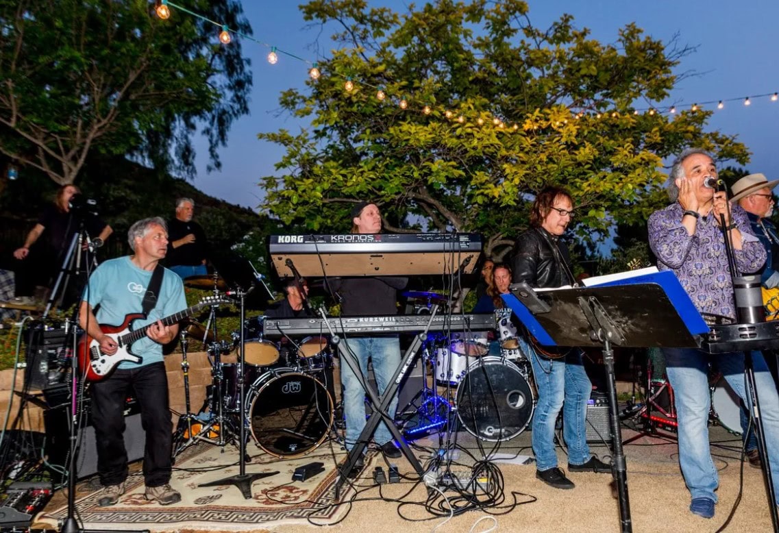 Live outdoor concert at Channel Islands Harbor featuring Ignition Band performing on stage.