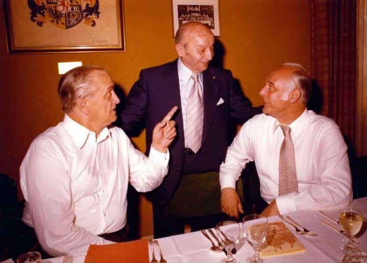 Drei Männer im Gespräch an einem Restauranttisch
