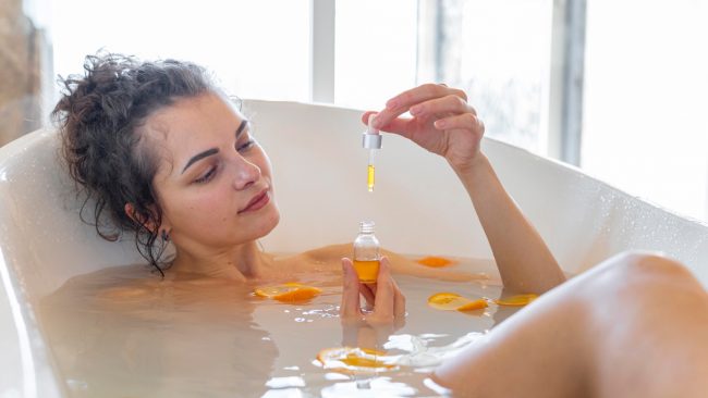 lady in the bath with aromatherapy oil