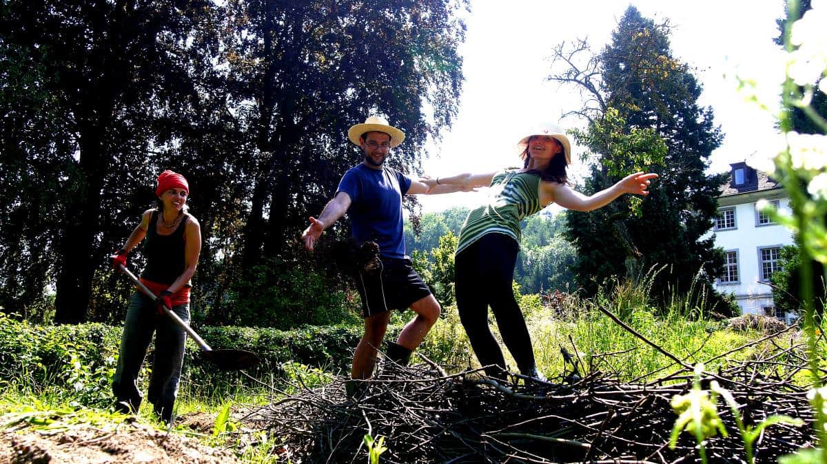People enjoying outdoor activities at a sustainable community event.