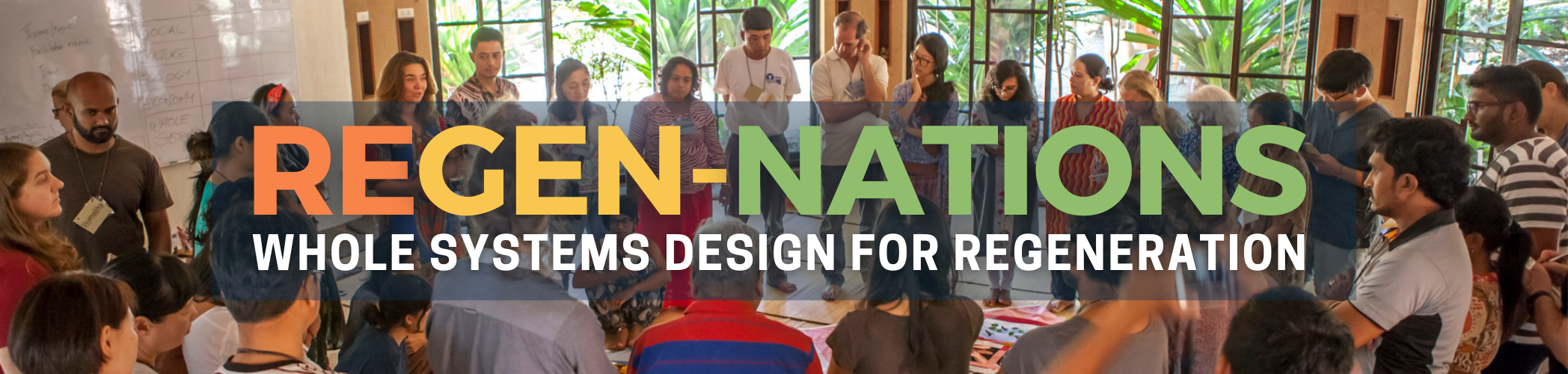 People gathered in a community space promoting sustainable living and regeneration.