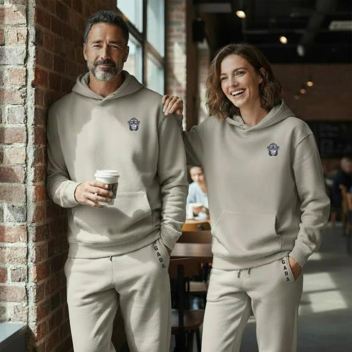 Comfortable grey tracksuit hoodie with small monkey logo, perfect for casual wear and active lifesty.