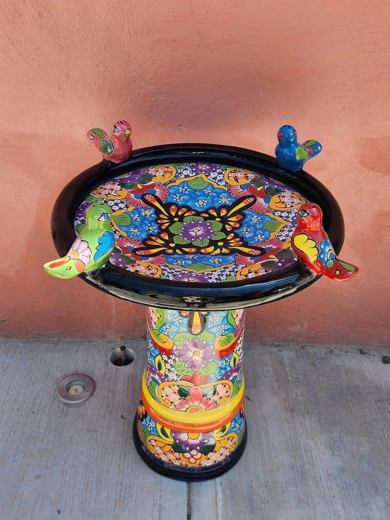 colorful ceramic bird bath with  birds