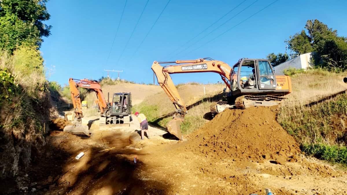 Excavators working on road construction site in New Zealand.
