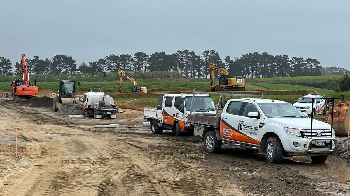 Excavation site with construction vehicles and equipment in progress in New Zealand.