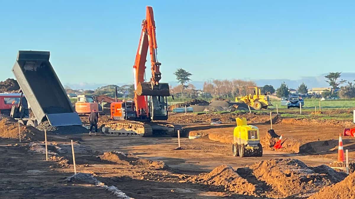 Excavator working on construction site for landscaping and earthworks in New Zealand.