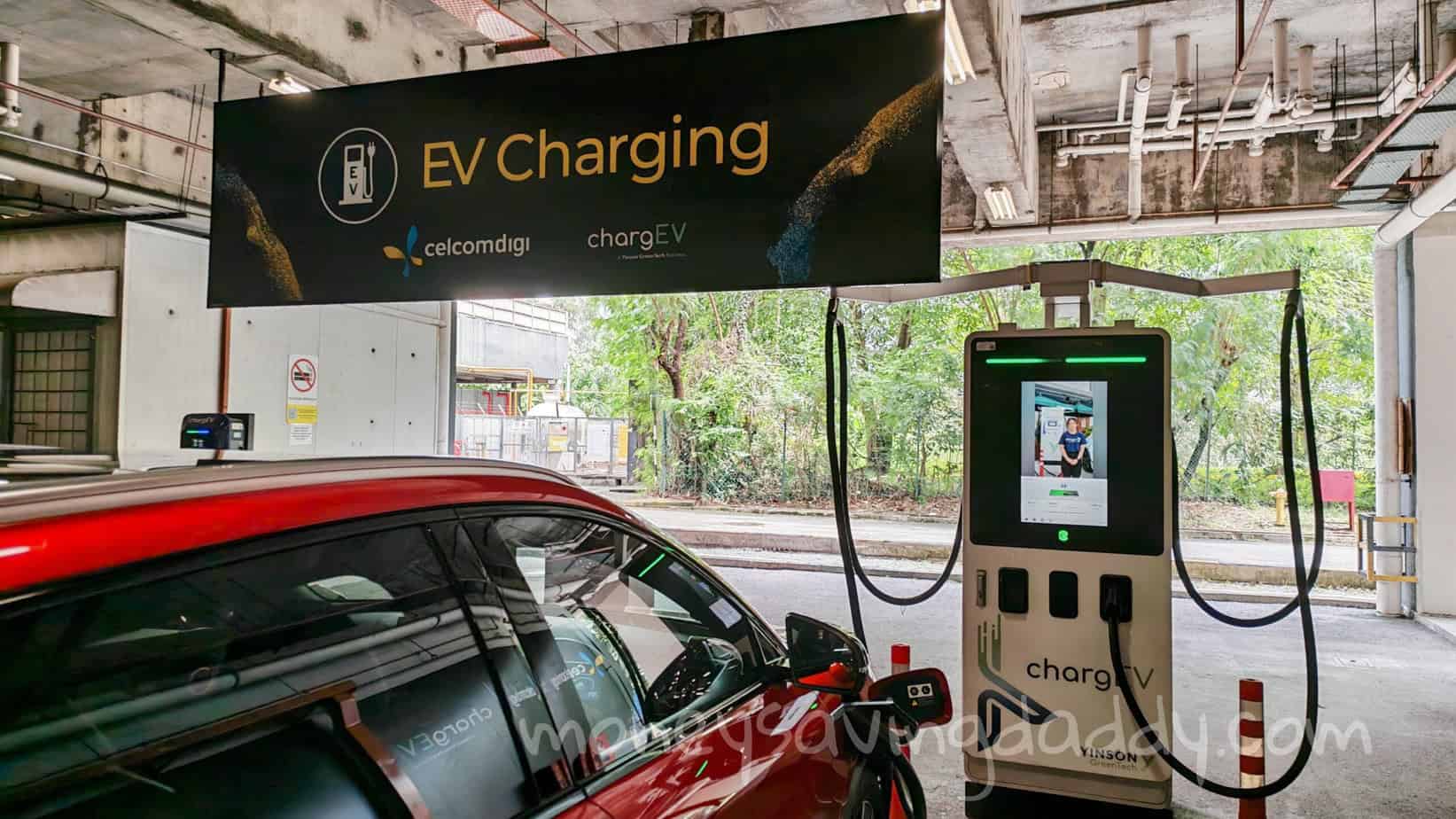 EV charging station at a parking garage, with a car plugged in for charging.