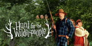Group of characters from "Hunt for the Wilderpeople" in a forest setting.