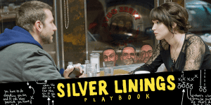 Podcast hosts discussing Silver Linings Playbook at a cozy cafe table.