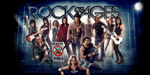 Cast of Rock of Ages musical performing on stage with guitars and microphones.