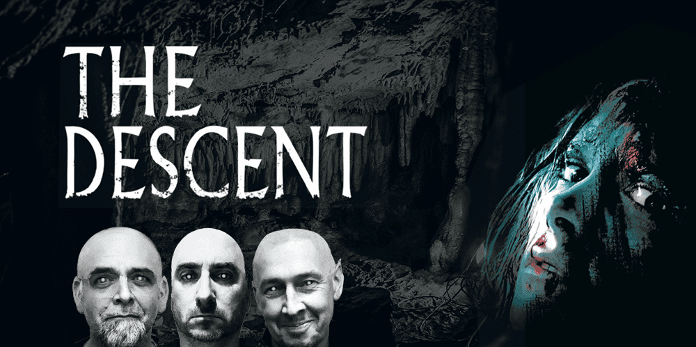 The Descent movie poster featuring three men and a woman in a dark cave setting.