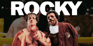 Scene from Rocky featuring Apollo Creed and Rocky Balboa in boxing attire.