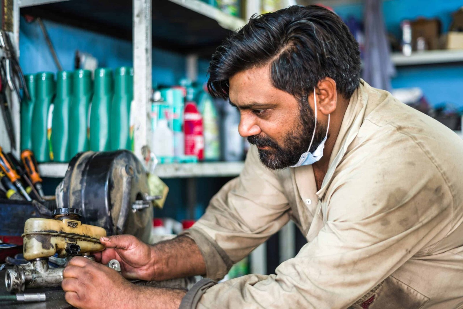 Mechanic repairing petrol scooter in india