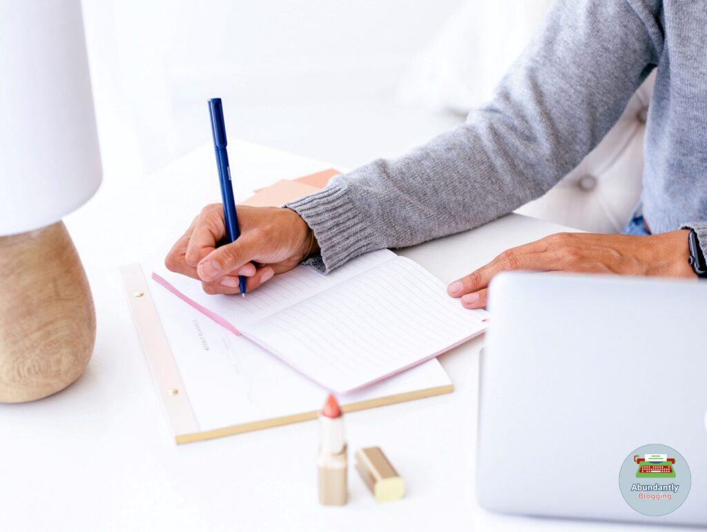 lady behind her desk writing in her notebook to work through the 8 steps to set goals