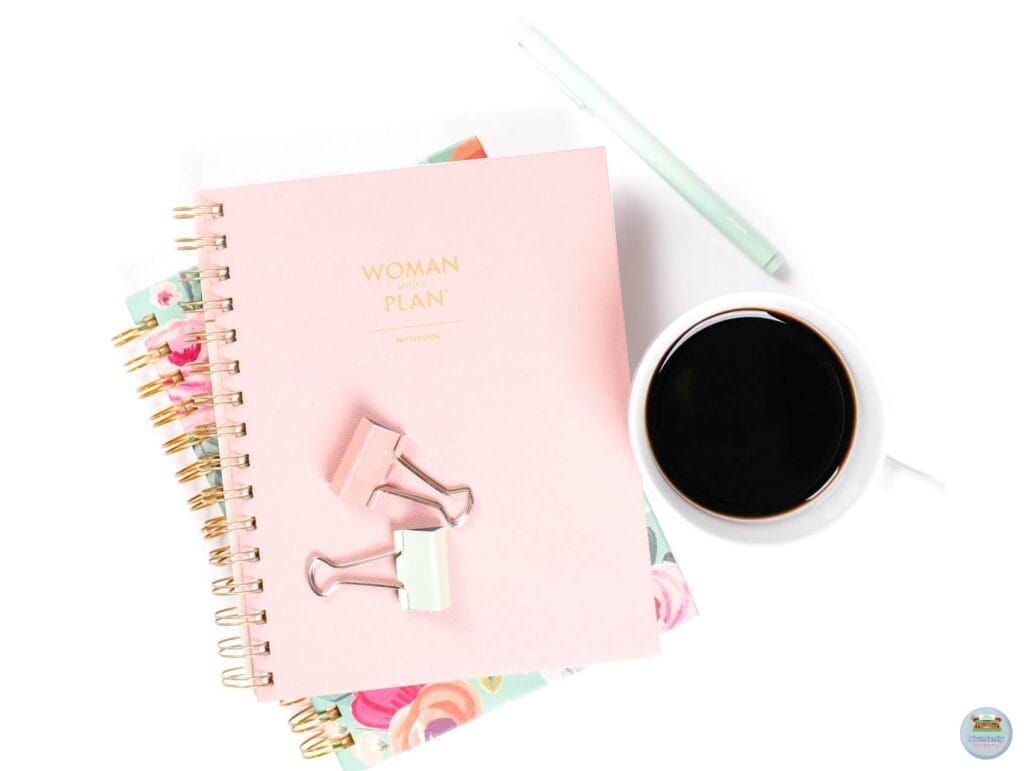 Planner and coffee - fueling productivity. Two notebooks, a pen, and a cup of coffee - Benefits of Work-Life Balance
