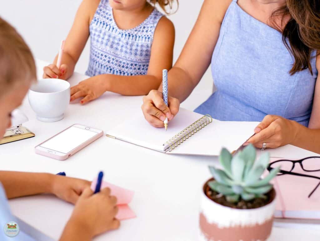 A loving mother enjoying quality time with her children around the table writing and coloring - Benefits of Work-Life Balance