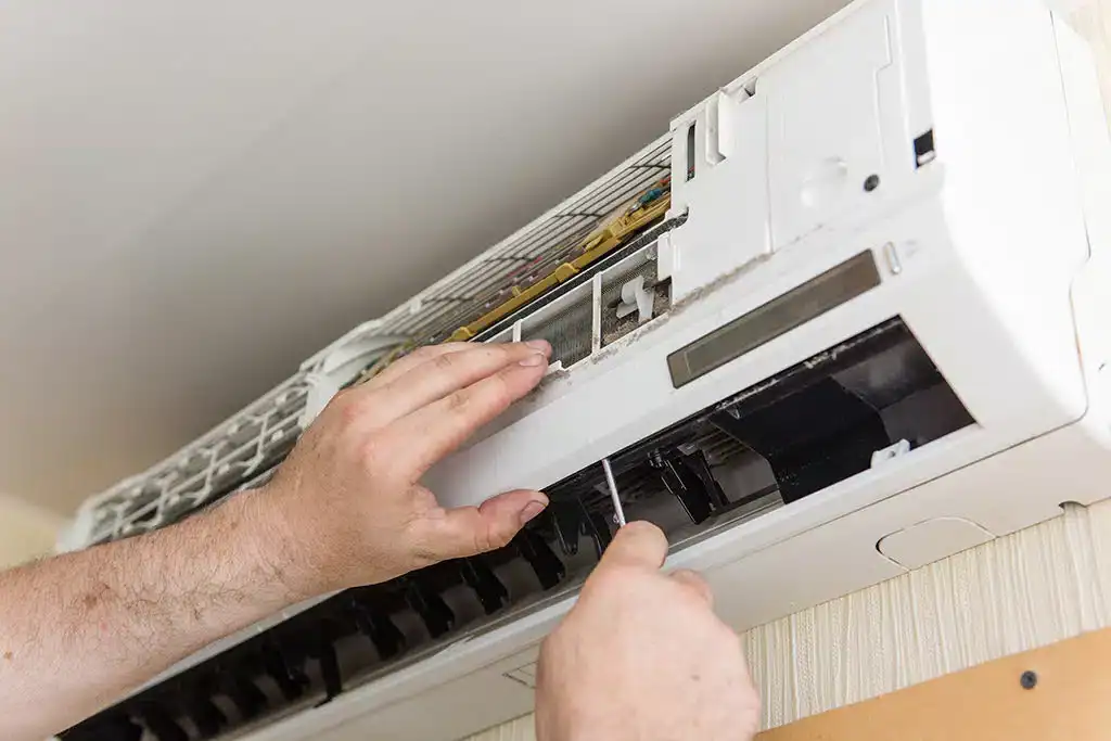 Hands-Repairing-Indoor-AC-Unit