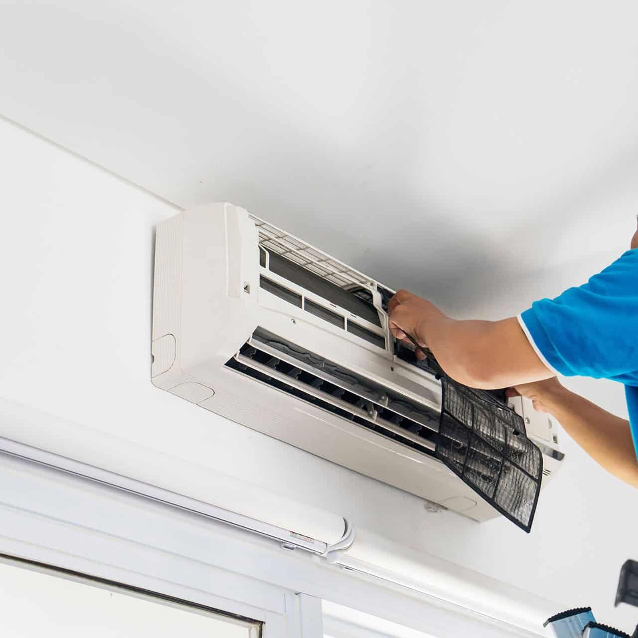 Technician-Removing-Wall-AC-Filter