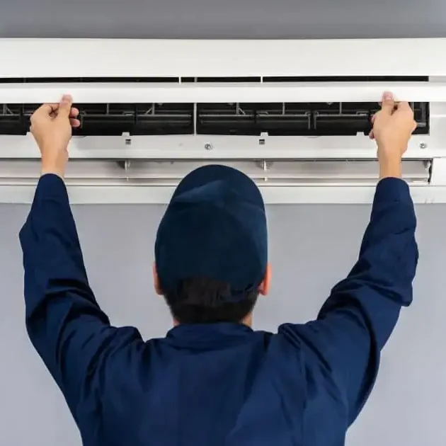 Technician-Opening-Wall-AC-Unit