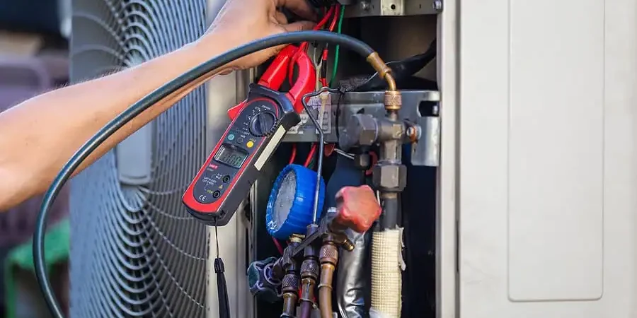 Technician Testing HVAC Electrical Components