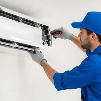 technician-repairing-white-wall