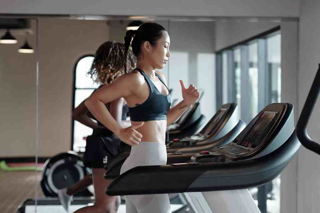 Young Woman Jogging on Treadmill