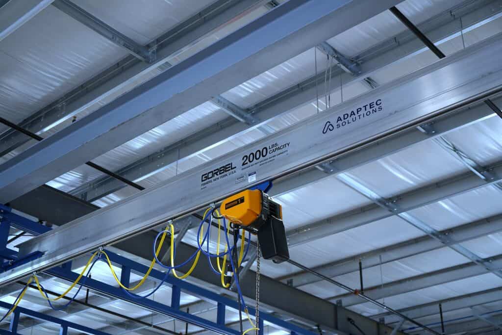 Industrial installation with overhead crane and safety equipment at Adaptec Solutions.