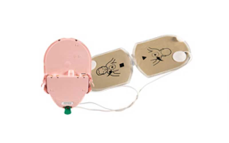AED trainer with defibrillator pads and cables