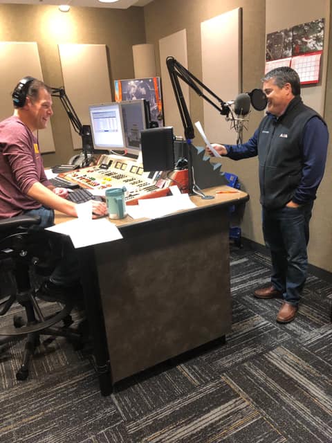 Two men recording in a radio studio.