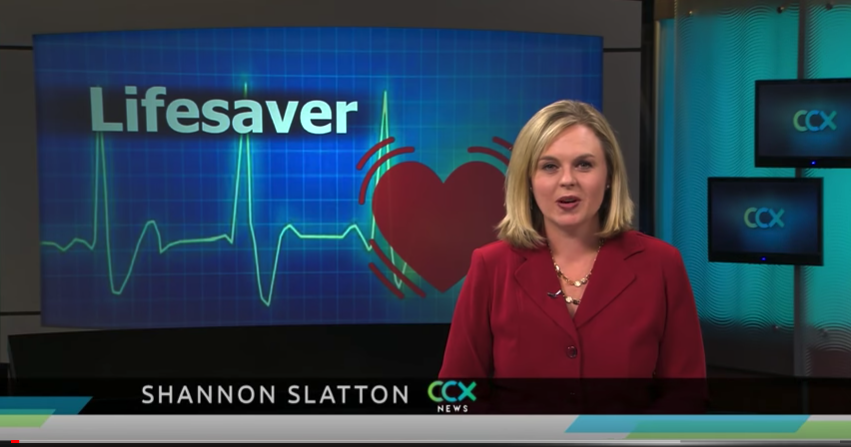 News anchor with heart and heartbeat graphic backdrop