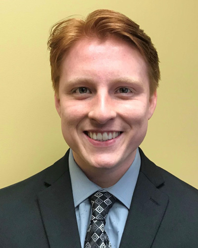 Smiling red-haired man in suit and tie