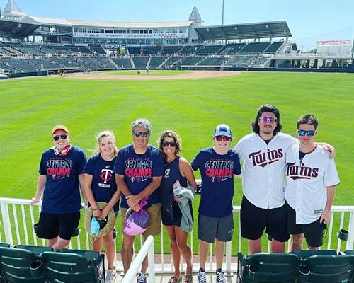 Group in Twins jerseys at baseball stadium