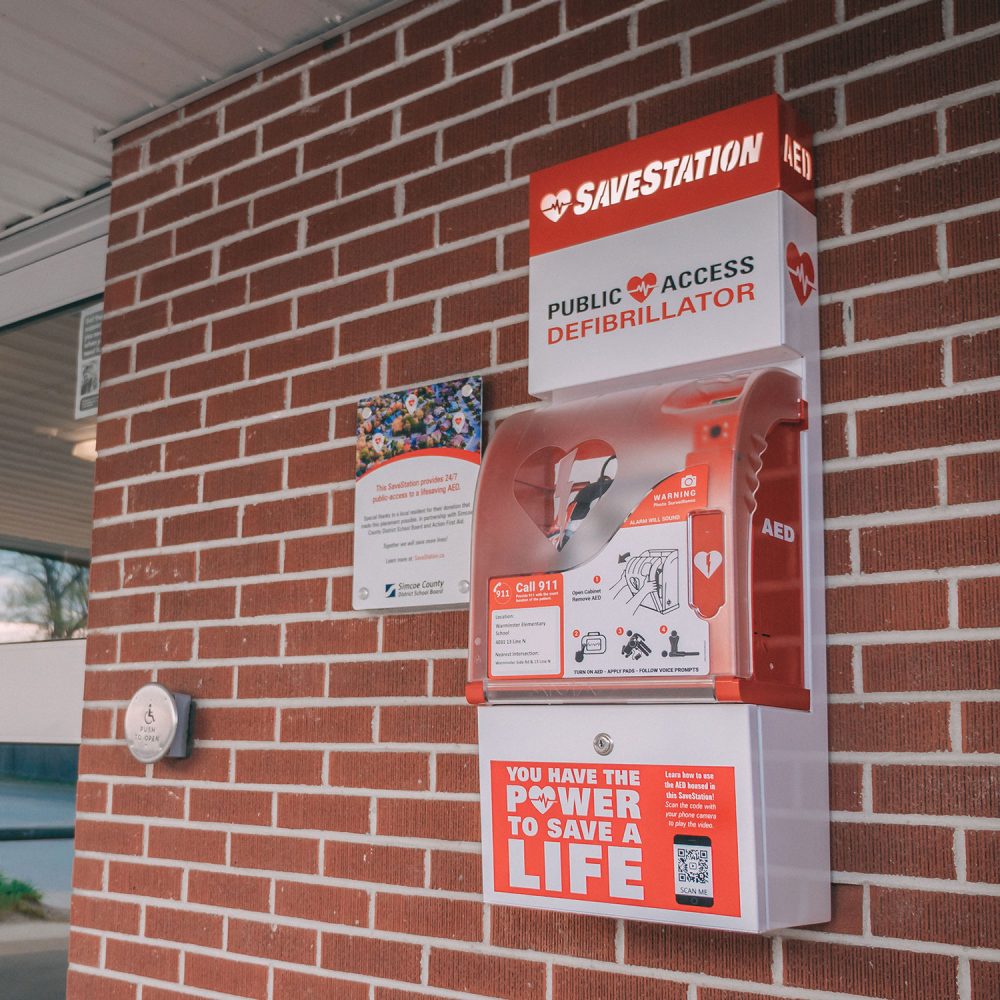 Public access defibrillator mounted on brick wall