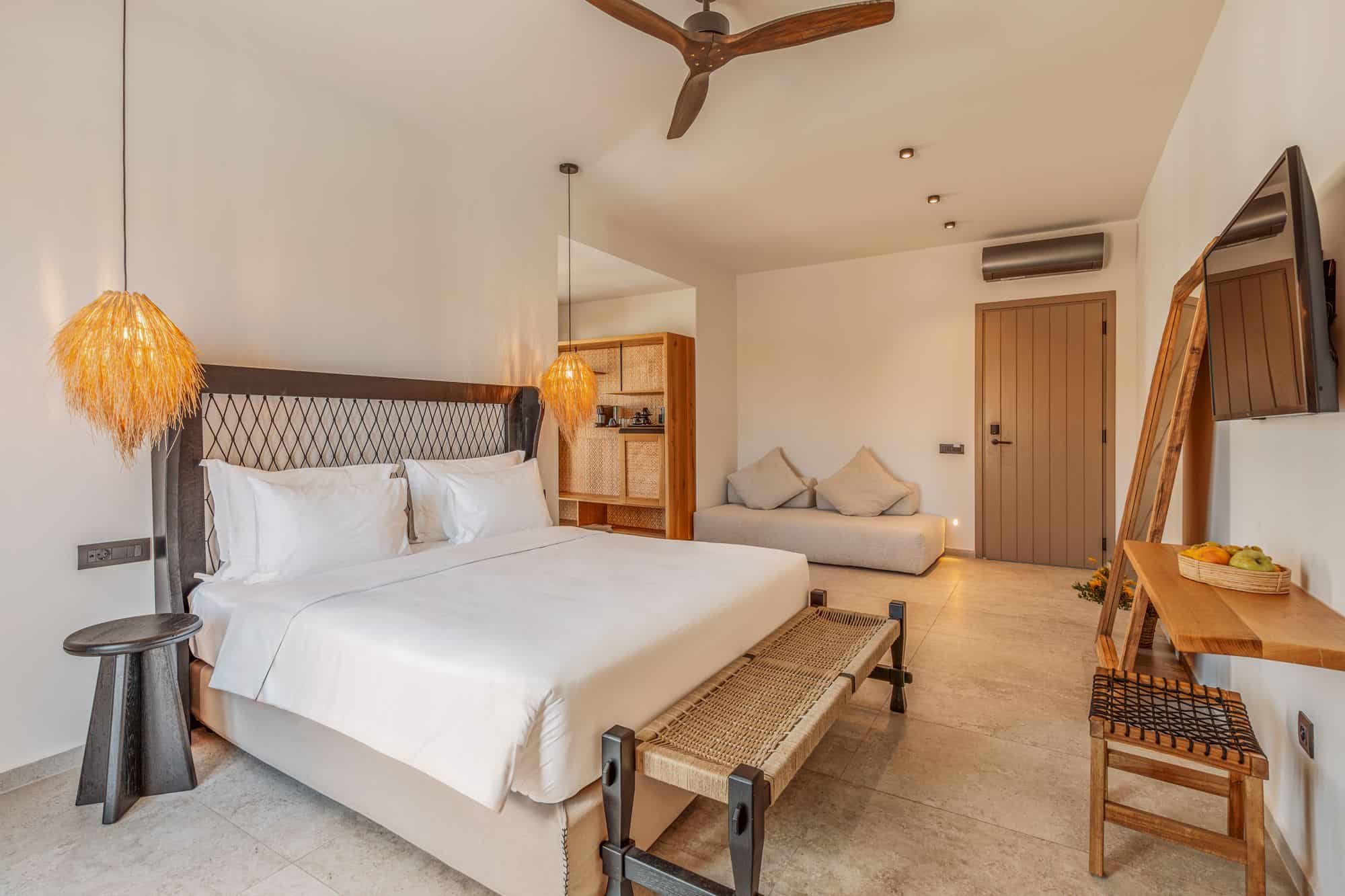 Elegant bedroom in Mykonos villa featuring a king-sized bed, stylish lighting, and relaxing interior design.