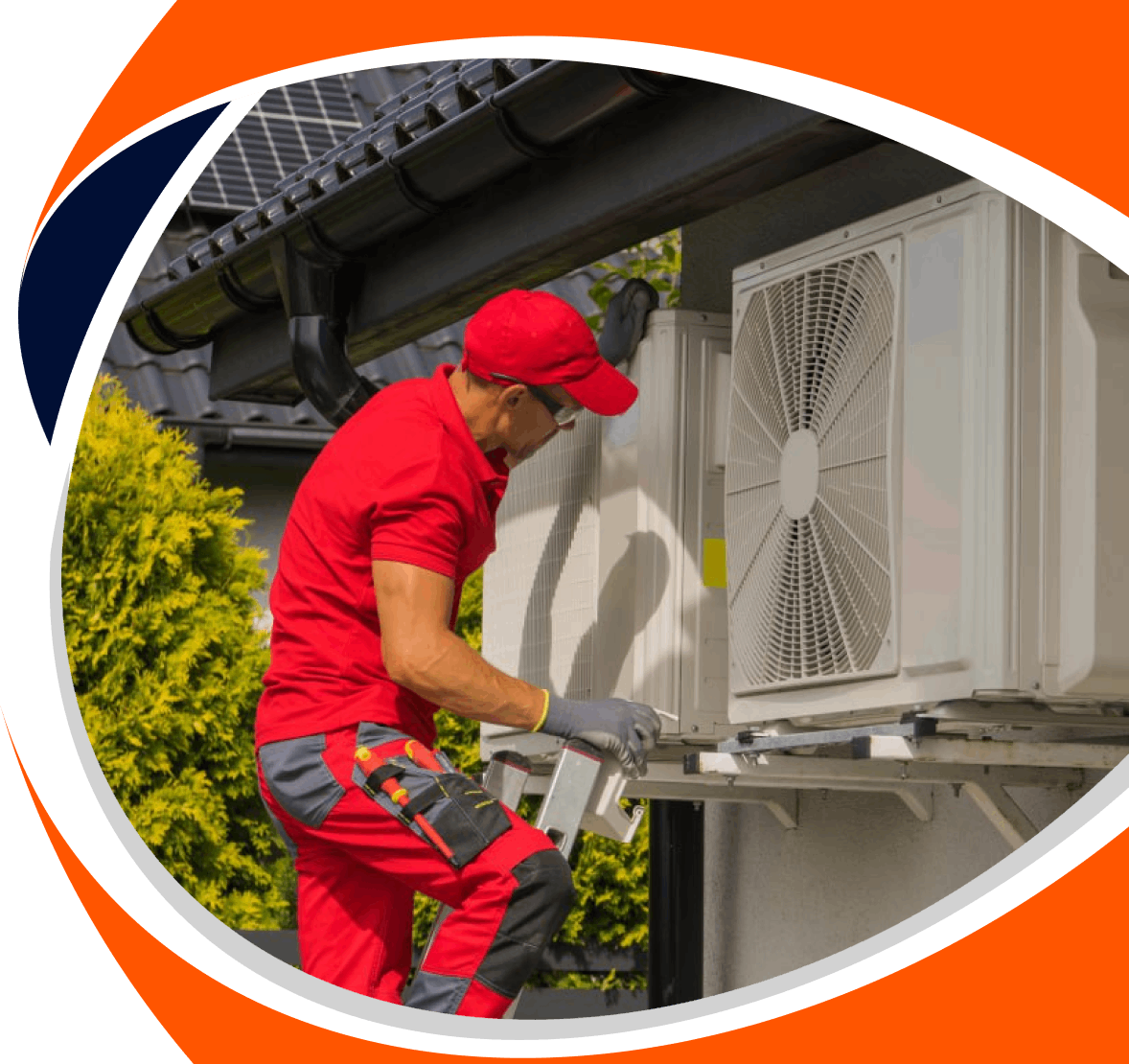 Man in red uniform working on outdoor air conditioning units on a building.