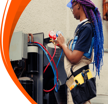 Woman technician checking an outdoor air conditioning unit with gauges