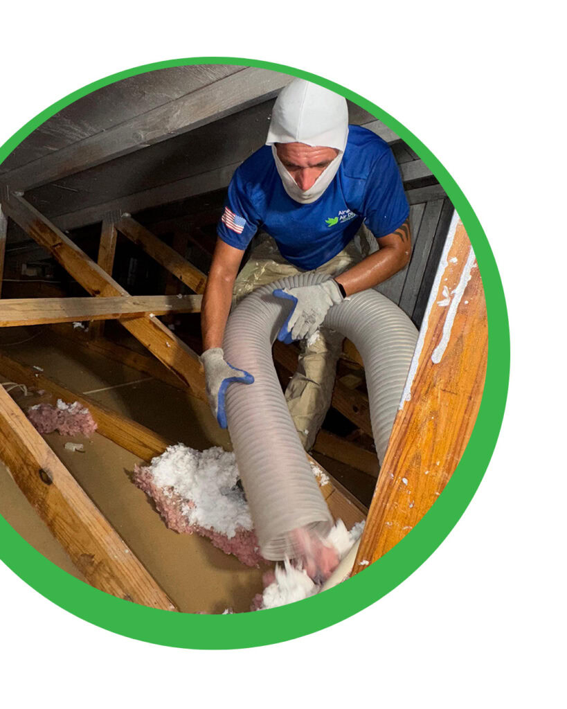 Man installing insulation in an attic