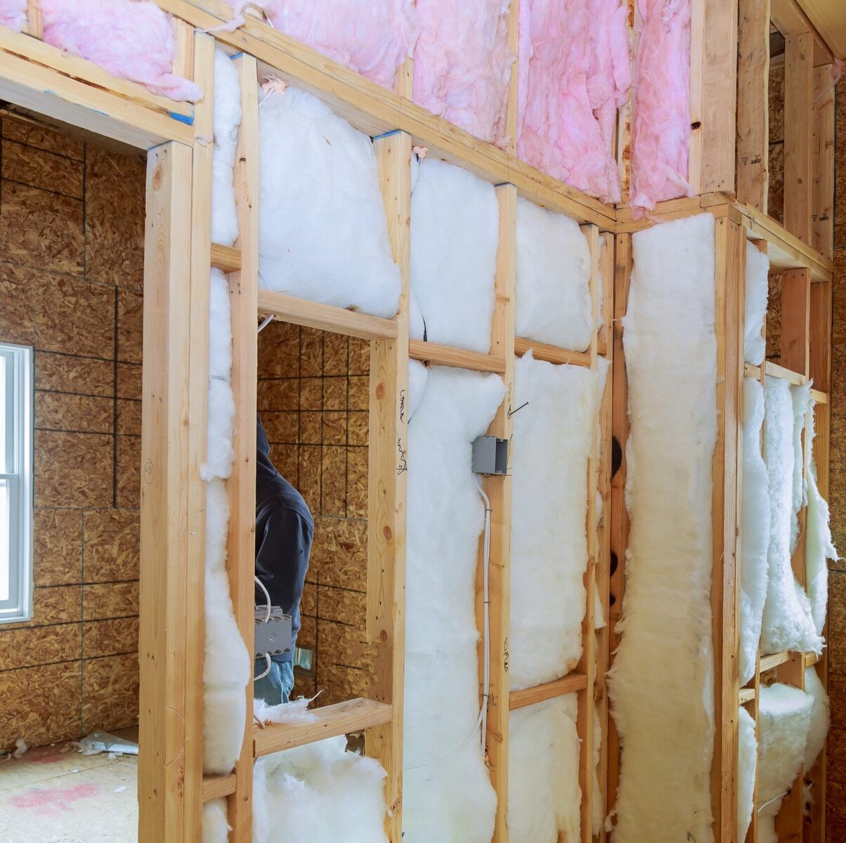 http://Interior%20view%20of%20a%20house%20under%20construction%20with%20insulation%20and%20wooden%20framing.