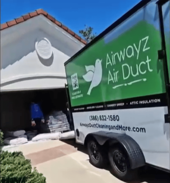 Airwayz Air Duct trailer parked in front of a garage with insulation