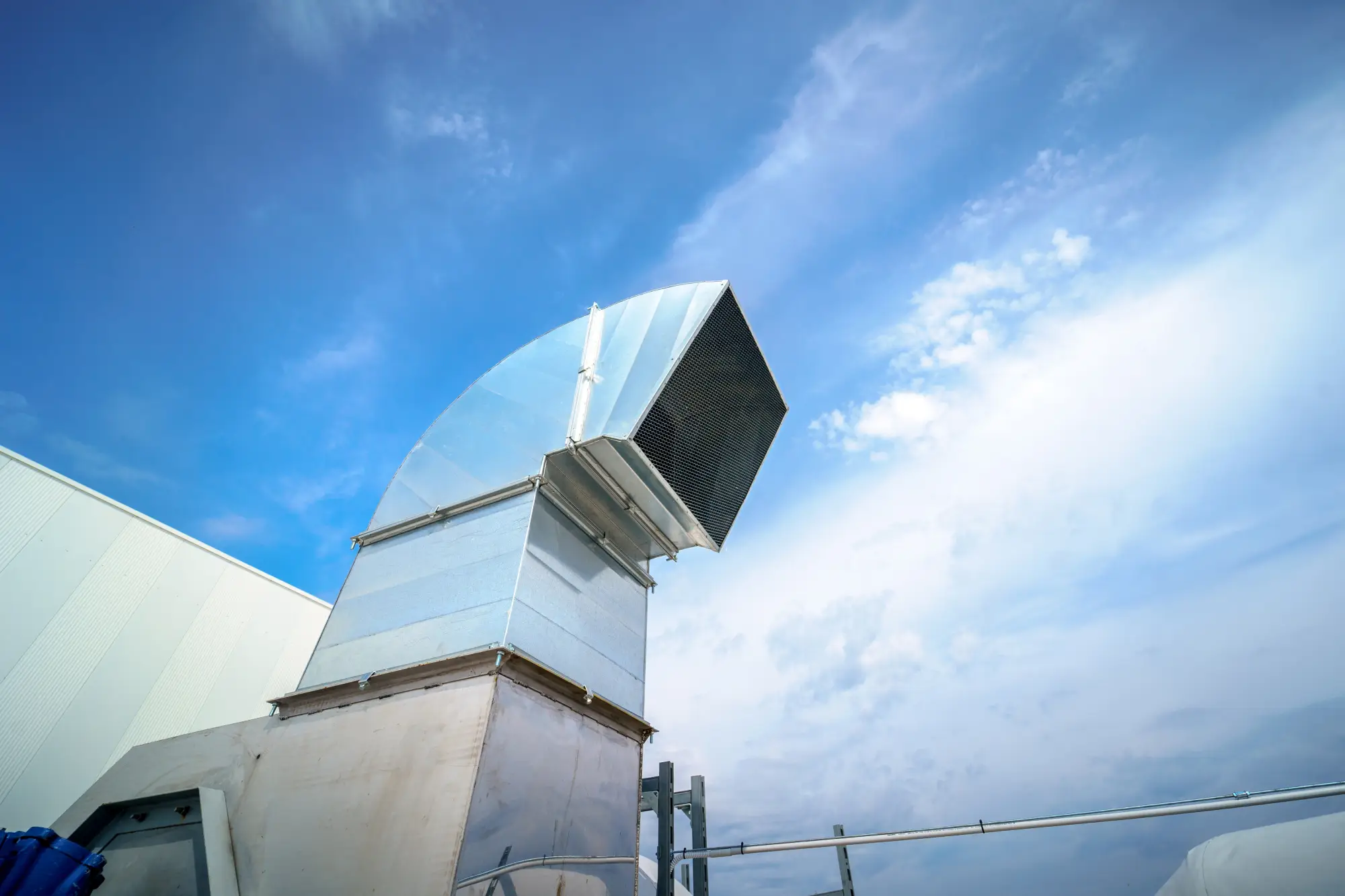 http://Large%20industrial%20air%20duct%20system%20on%20a%20rooftop%20against%20a%20blue%20sky.
