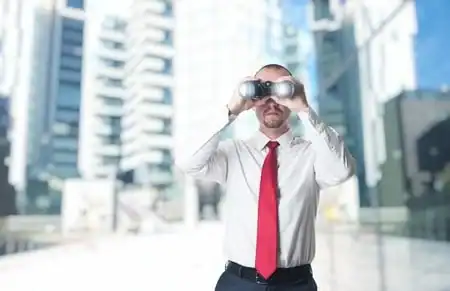 Businessman using virtual reality glasses in an urban setting.