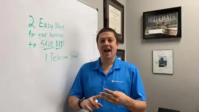 Person in blue shirt presenting business tips on whiteboard.