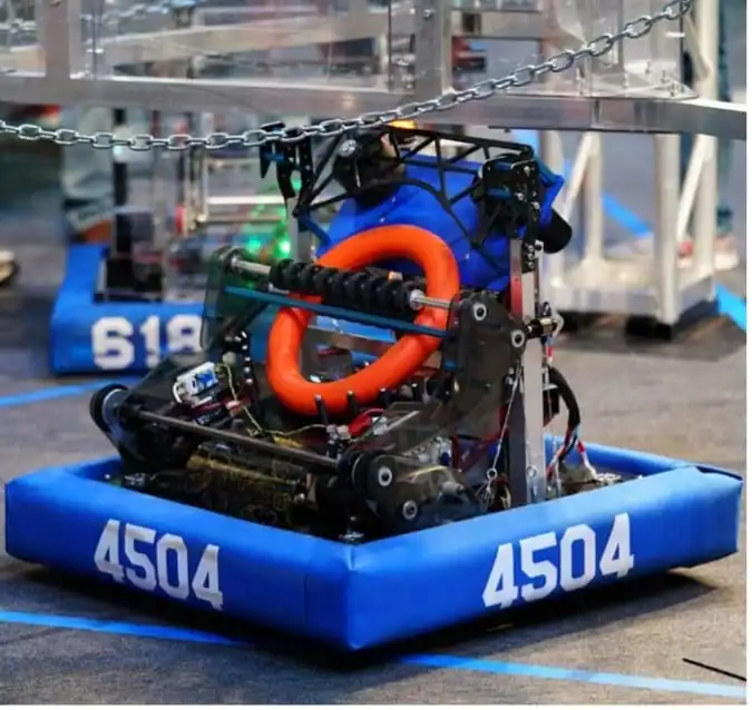 Robotic competition robot with blue base and orange tubing at STEM event.
